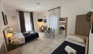 a hotel room with two beds and a dining room at La Maison Rose in Maiori +37 photos