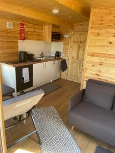 a living room with a couch and a kitchen at Lakeside Lodge 2, With Log burning Hot tub in Everton