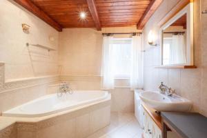 a bathroom with a tub and a sink at Hotel Hvezda in Pec pod Sněžkou +152 photos
