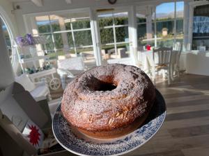 a large bundt cake on a plate on a table at Ca' del Conte - Maison de Charme in Padula