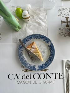 a plate with a piece of cake on a table at Ca' del Conte - Maison de Charme in Padula
