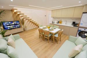 a kitchen and dining room with a table and chairs at Arial Lofts in Vlorë