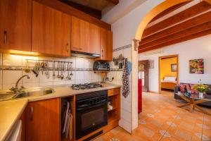 a kitchen with a sink and a stove top oven at Finca Ladimora in Capdepera