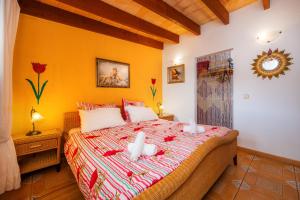 a bedroom with a bed with two stuffed animals on it at Finca Ladimora in Capdepera