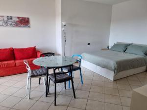 a bedroom with a bed and a table and chairs at Studio with terrace in Busto Arsizio