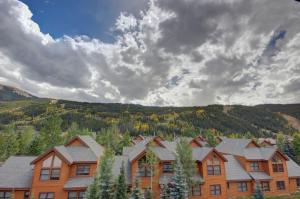 a large house with a mountain in the background at Snake River 44 by SummitCove Lodging in Keystone
