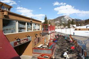 a group of people sitting outside of a building at Snake River 44 by SummitCove Lodging in Keystone