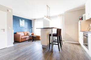 a kitchen and living room with a table and chairs at Fehmarnstrand 78 App 9 in Staberdorf