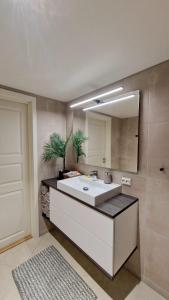 a bathroom with a sink and a mirror at Rancho Apartment with King size bed in Sula +26 photos