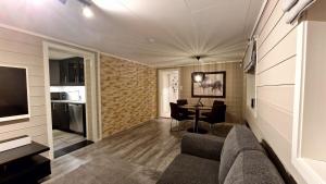 a living room with a couch and a table at Rancho Apartment with King size bed in Sula