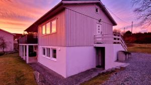 a large white house with a gambrel roof at Rancho Apartment with King size bed in Sula