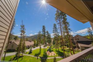 a view from the balcony of a house with a yard at Quicksilver 1639 by SummitCove Lodging in Keystone