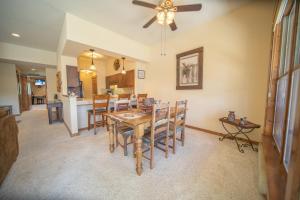 a dining room and kitchen with a table and chairs at Quicksilver 1639 by SummitCove Lodging in Keystone