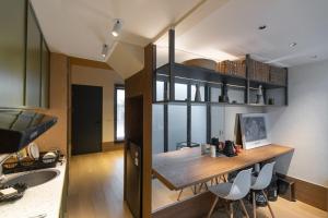 a kitchen with a table and chairs in a room at Beautiful japandi house frejahouse in Kedeper