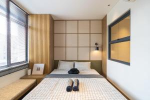 a bedroom with a bed with a pair of shoes on it at Beautiful japandi house frejahouse in Kedeper