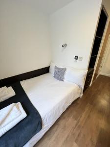 a bedroom with a large bed with white sheets at Astor House by Pureserviced in Plymouth