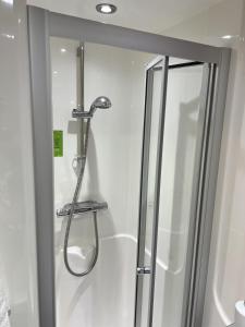 a shower in a bathroom with a glass door at Astor House by Pureserviced in Plymouth