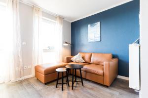 a living room with a couch and a table at Fehmarnstrand 78 App 12 in Staberdorf