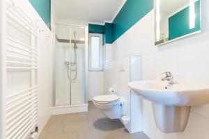 a bathroom with a sink and a toilet and a shower at Fehmarnstrand 78 App 12 in Staberdorf +7 photos