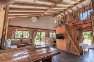 a living room with a wooden table and a couch at Cabaña en Pucon in Pucón
