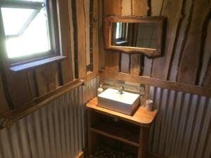 a bathroom with a sink and a mirror at Cabaña en Pucon in Pucón +32 photos