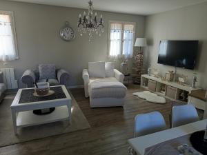 a living room filled with furniture and a flat screen tv at Appartement cosy in Le Croisic