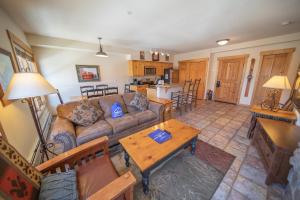 a living room with a couch and a table at Tenderfoot Lodge 2620 by SummitCove Lodging in Keystone