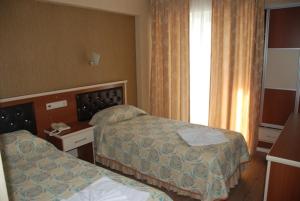 Postel nebo postele na pokoji v ubytování Epic Hotel
