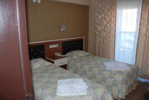 Postel nebo postele na pokoji v ubytování Epic Hotel