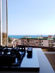 a table in a room with a view of a city at Almarisa - appartamento vista mare in Salerno