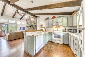 a kitchen with white cabinets and wooden floors at Half-Mi to Midtown Family Retreat with Mtn Views! in Ruidoso