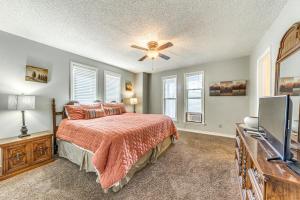 a bedroom with a bed and a flat screen tv at Half-Mi to Midtown Family Retreat with Mtn Views! in Ruidoso