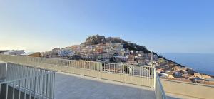 a view of a town on a hill next to the ocean at Residenza Albachiara in Castelsardo