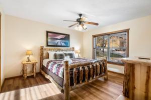 a bedroom with a bed and a window at Cozy 'Rustic River Lodge' Near SDC with Pools! in Branson +16 photos