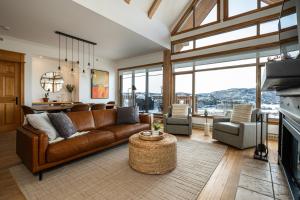 a living room with a brown leather couch and chairs at Tremblant Prestige - Altitude 168-9 in Mont-Tremblant