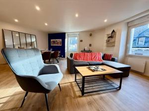a living room with a couch and a table at Coeur de ville in Saint-Brieuc +7 photos