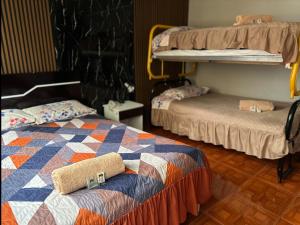 a room with two bunk beds with towels on the bed at Hotel Villamar in Quito