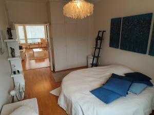a bedroom with a large bed with blue pillows at Spacious and bright apartment for 4 in Helsinki