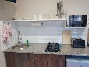 a kitchen with a sink and a counter top at Willow's Corner-Just like home! in Durban +4 photos