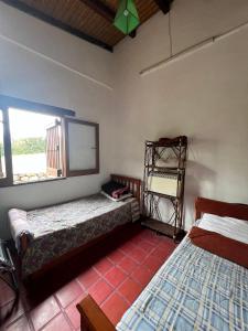 a room with two beds and a window at La Ramada in Tafí del Valle