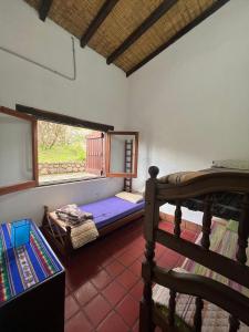 a room with a bunk bed and a window at La Ramada in Tafí del Valle