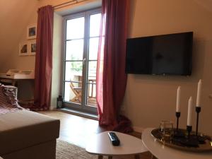 a living room with a bed and a large window at Ferienwohnung mit Sauna in Potsdam