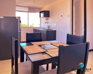 a kitchen with a table with chairs and a refrigerator at APARTAHOTELES BOOKUTRIP 2km PARQUE DEL CAFÉ -311-227-59-73 in Montenegro