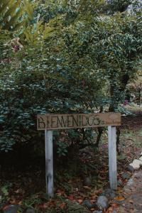 a sign in front of a bush with a tree at Mango Selva Bio Hotel in Actopan +35 photos