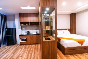 a hotel room with a bed and a sink at MHome in Ho Chi Minh City