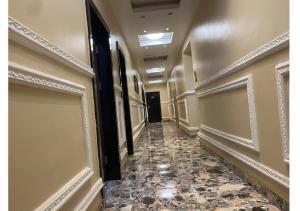 a hallway with a tile floor in a building at Grand Diamond Hotels & Suites LTD in Owerri