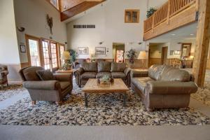 a living room with couches and a coffee table at Hidden River Lodge 5981 by SummitCove Lodging in Keystone