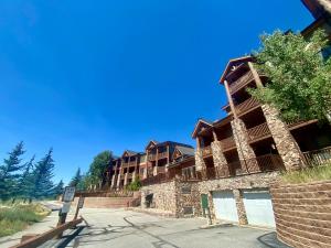 a large apartment building on the side of a street at Hidden River Lodge 5981 by SummitCove Lodging in Keystone +56 photos
