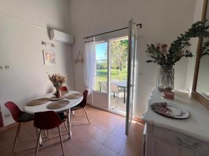 a kitchen with a table and chairs and a dining room at Gabin sous les Oliviers in Gallargues-Le-Montueux