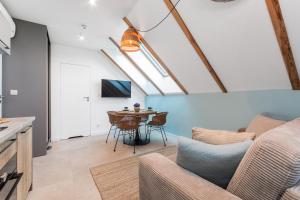 a living room with a couch and a table at Apartamenty Dwie Sosny in Junoszyno